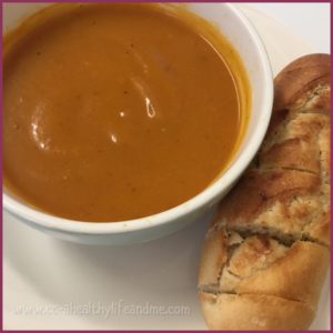 A bowl of butternut squash soup & garlic bread